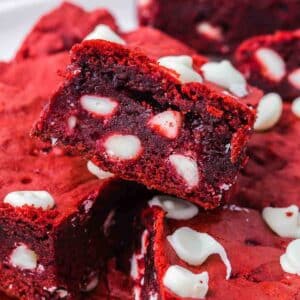 Red velvet brownies stacked on top of one another.