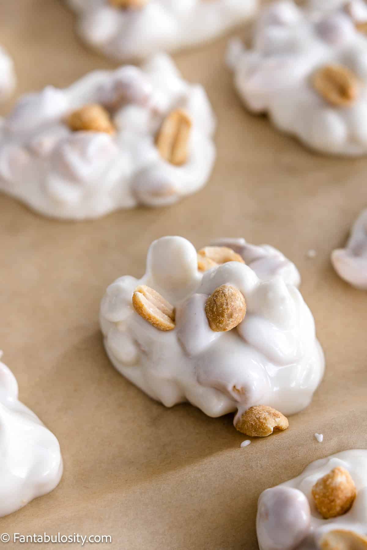 Extra peanuts sprinkled on top of white chocolate crock pot candy.