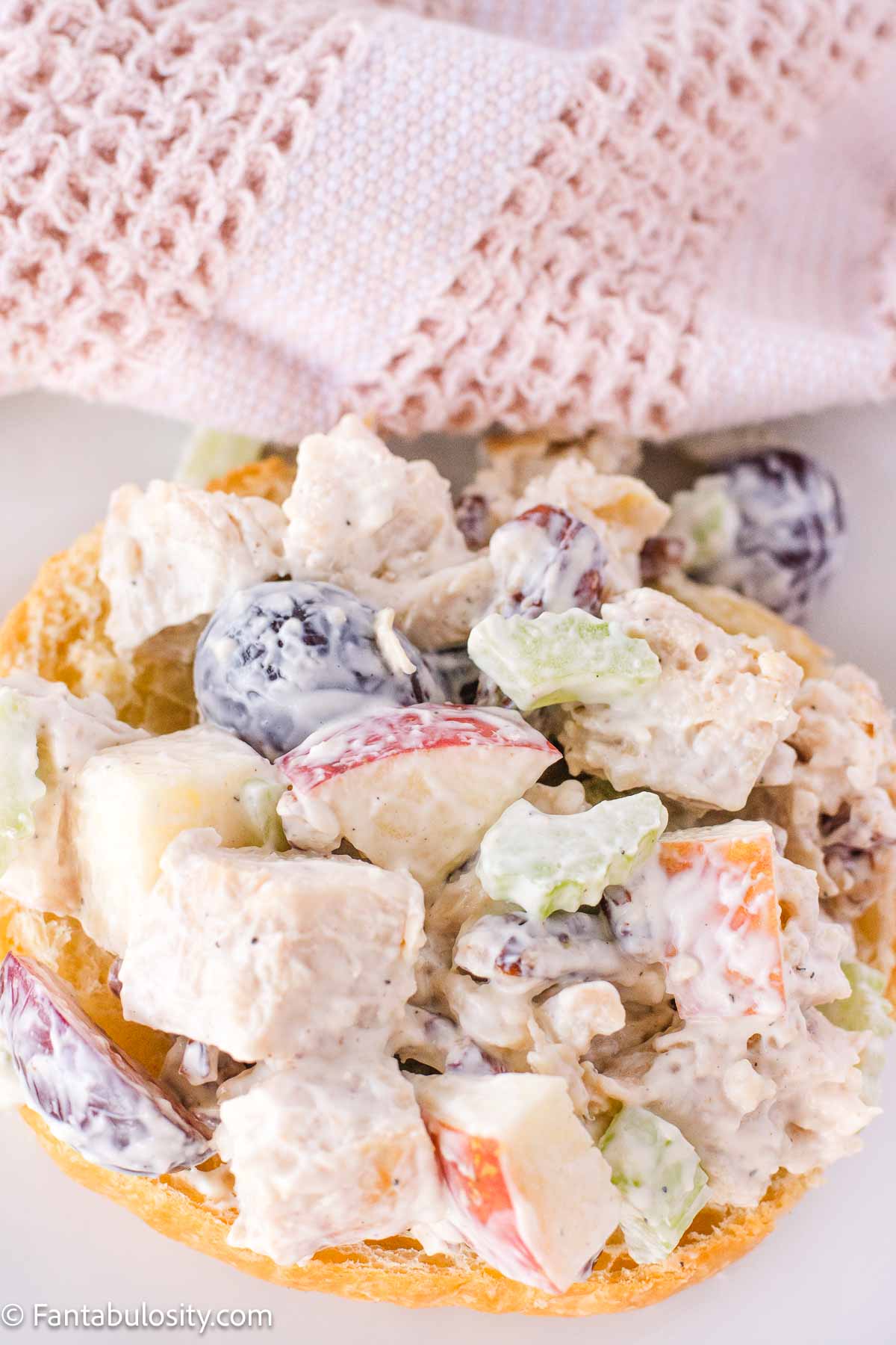 Chicken salad with grapes and apples on croissant. 