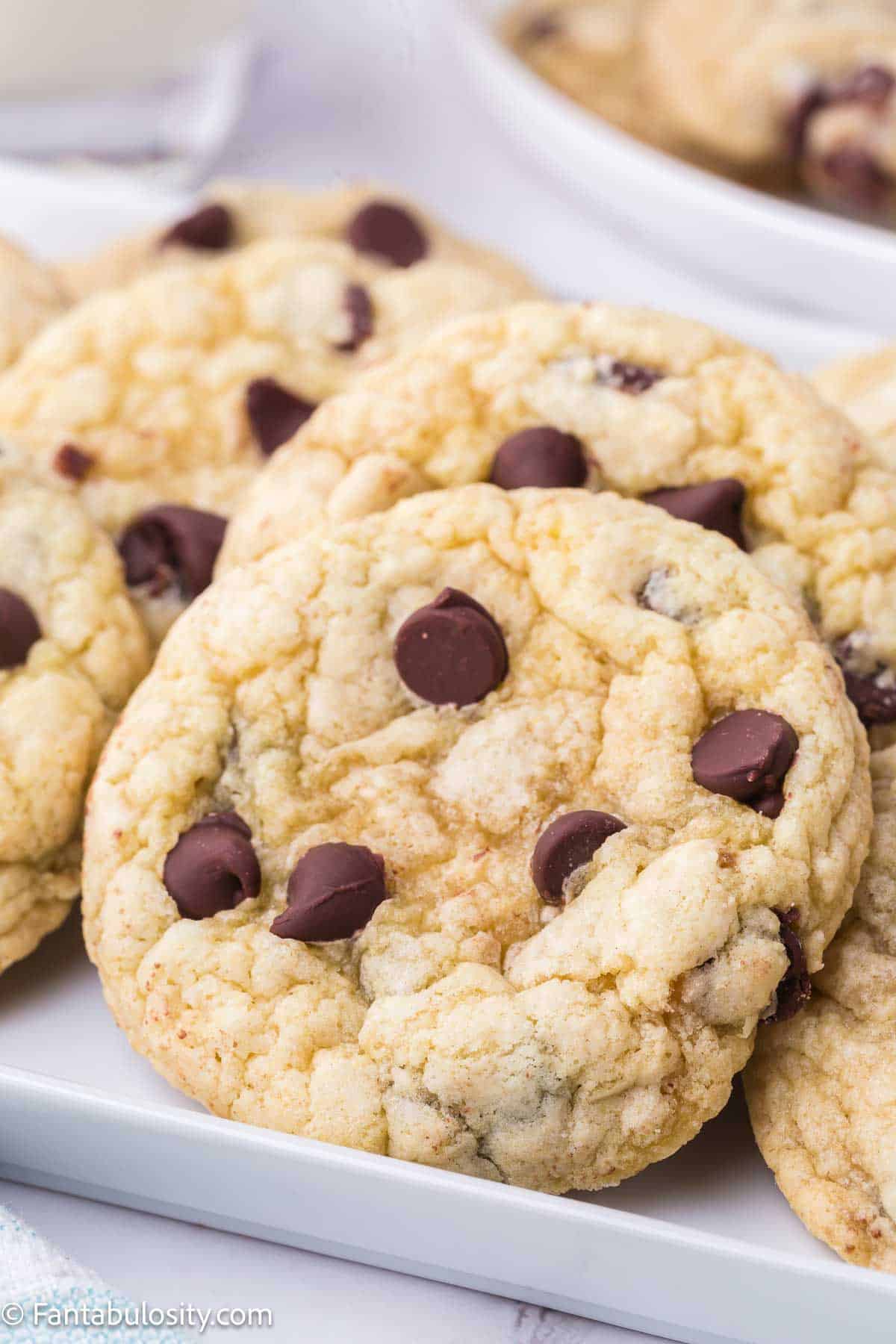 Chocolate chip sugar cookies placed on white platter.