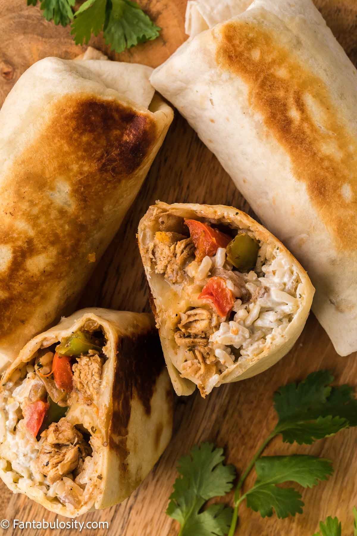 Cooked chicken fajita wraps cut in half.