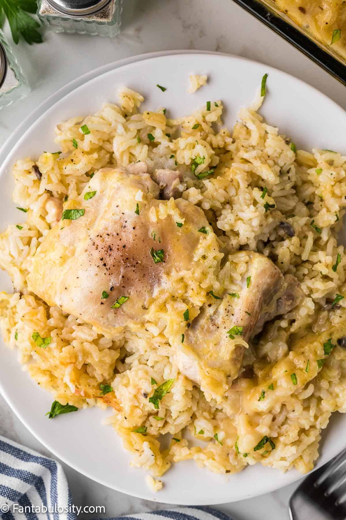 Serving of chicken and rice casserole on white plate.