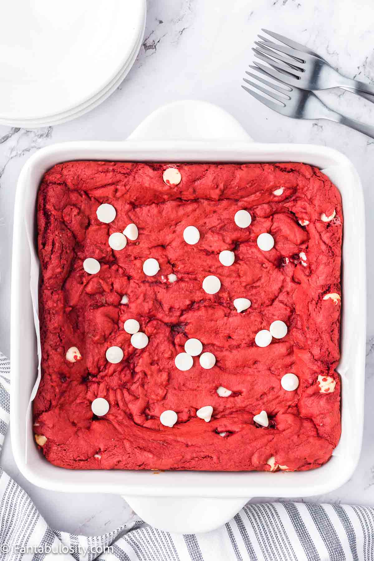 Baked red velvet brownies in a white baking pan.