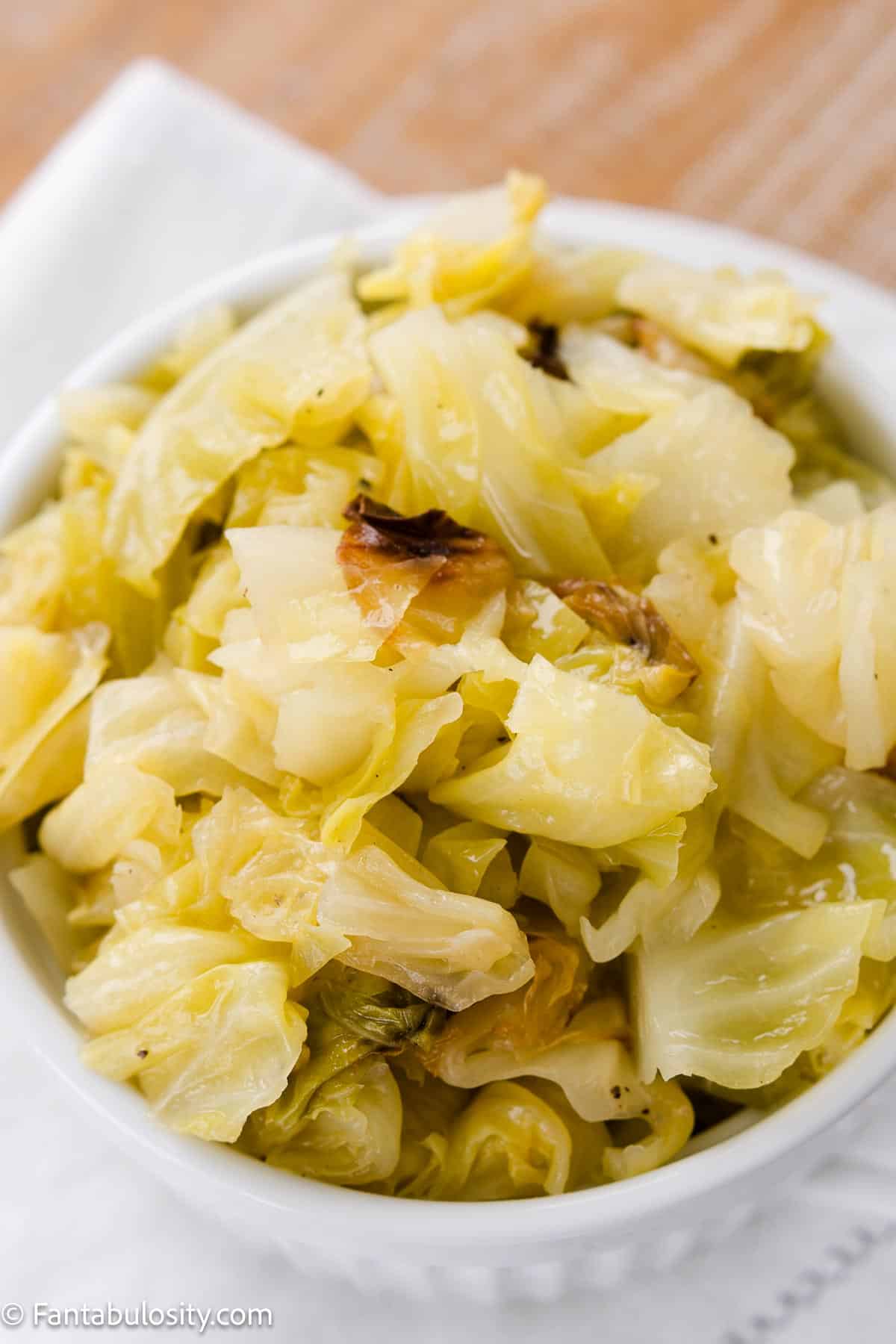 Cooked cabbage in a small white bowl.