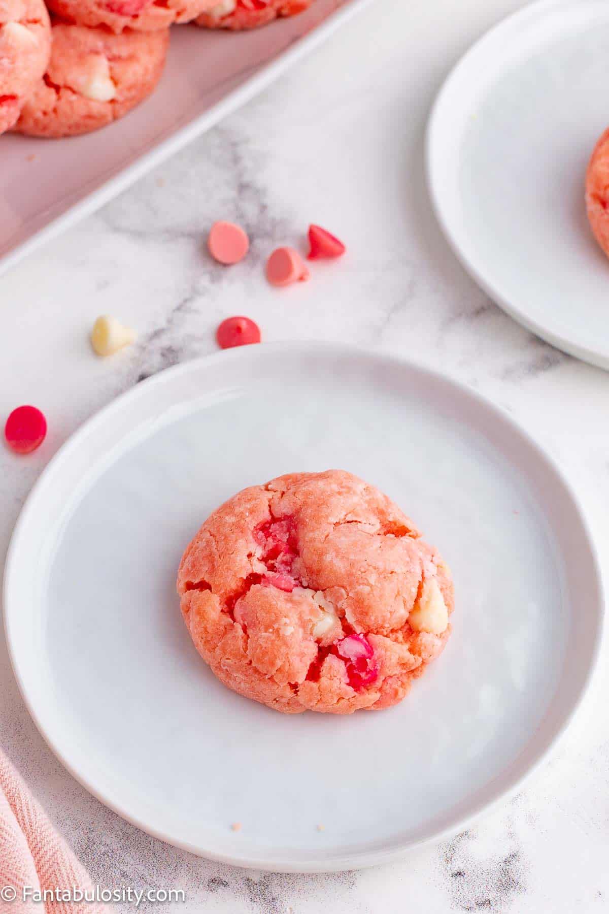 Strawberry cookie on white plate.