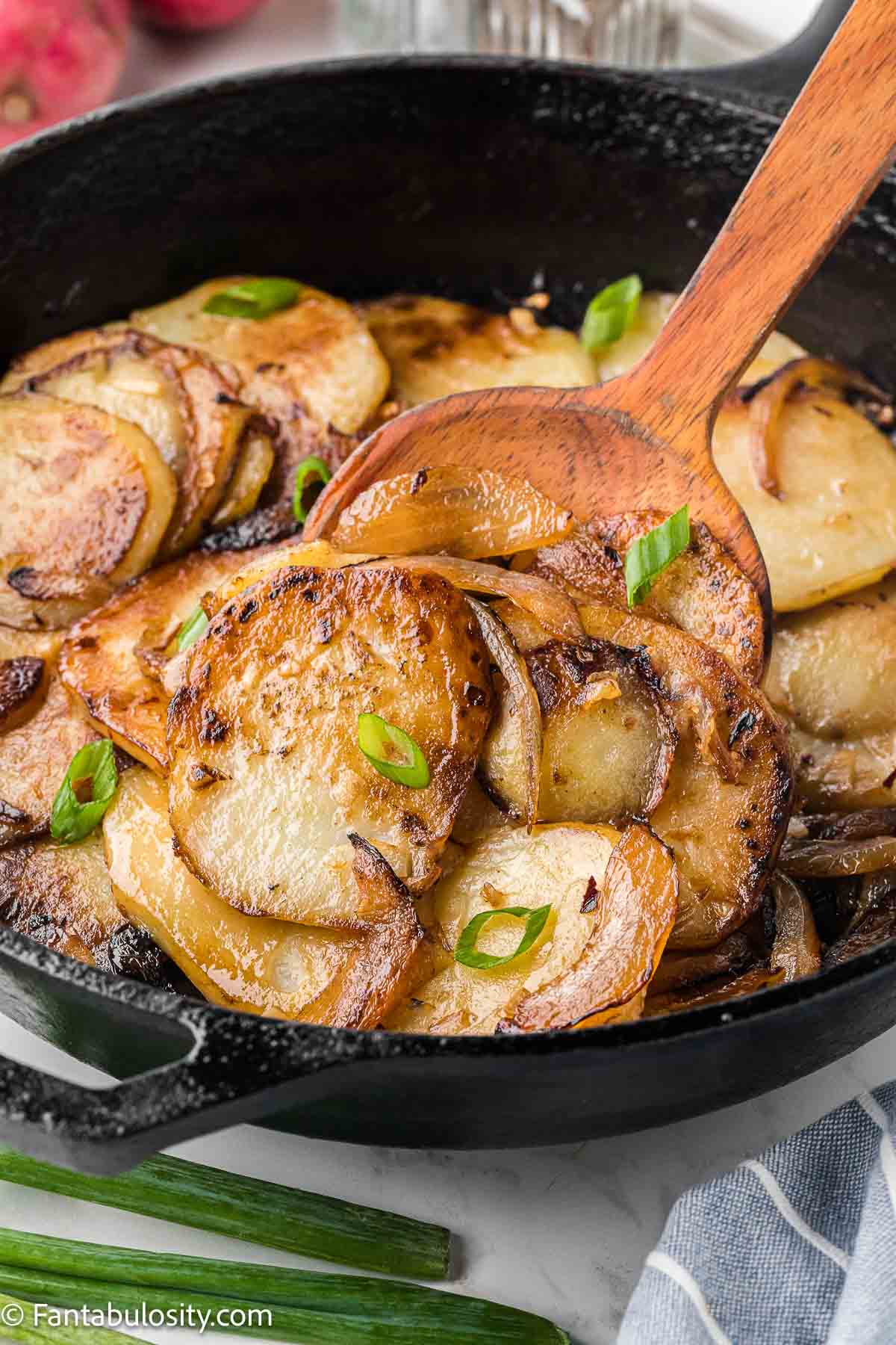 Cooked fried potatoes and onions in cast iron skillet.