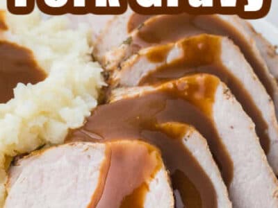 Close up of pork gravy drizzled on slices of pork.