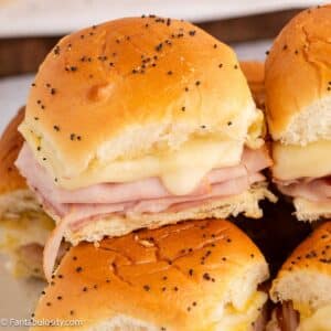 Ham and cheese sliders stacked on top of one another.