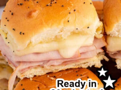 Side view of three ham and cheese sliders stacked on top of one another.