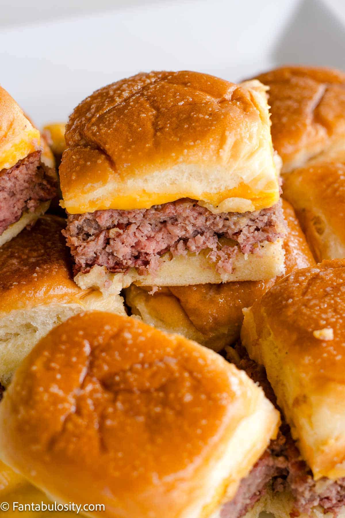 Cheeseburger sliders stacked on one another.