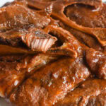 Crock pot pork steaks covered in bbq sauce.