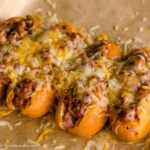 Chili cheese corn dogs on a baking sheet.