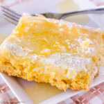 Slice of Gooey Butter Cake on a square plate, next to fork.