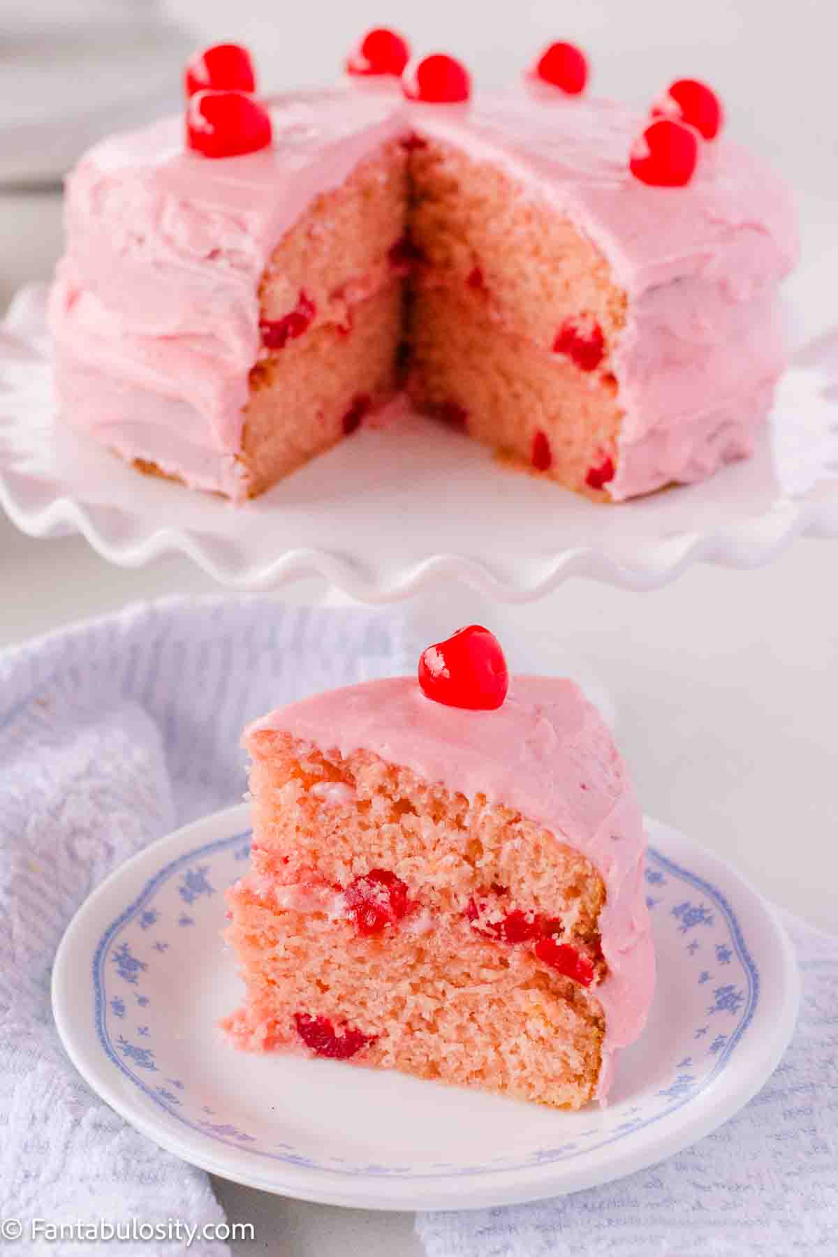 Cherry chip cake in 2-layers, showing a piece on a plate, and the rest of the cake in back.