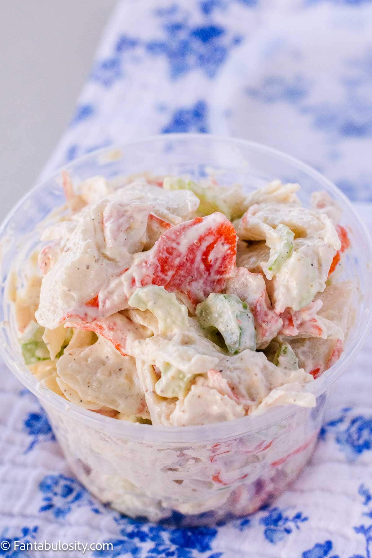 Crab salad in plastic container like a copycat deli recipe.