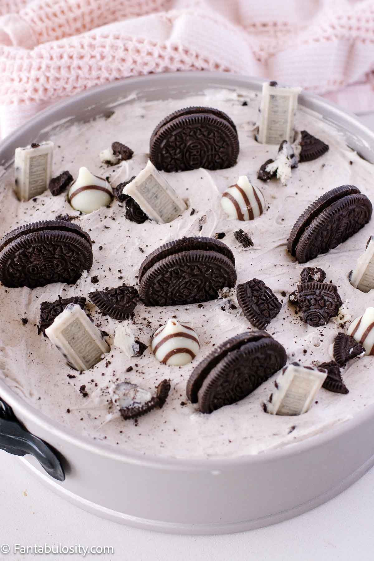 Oreo cheesecake in pan, with toppings.