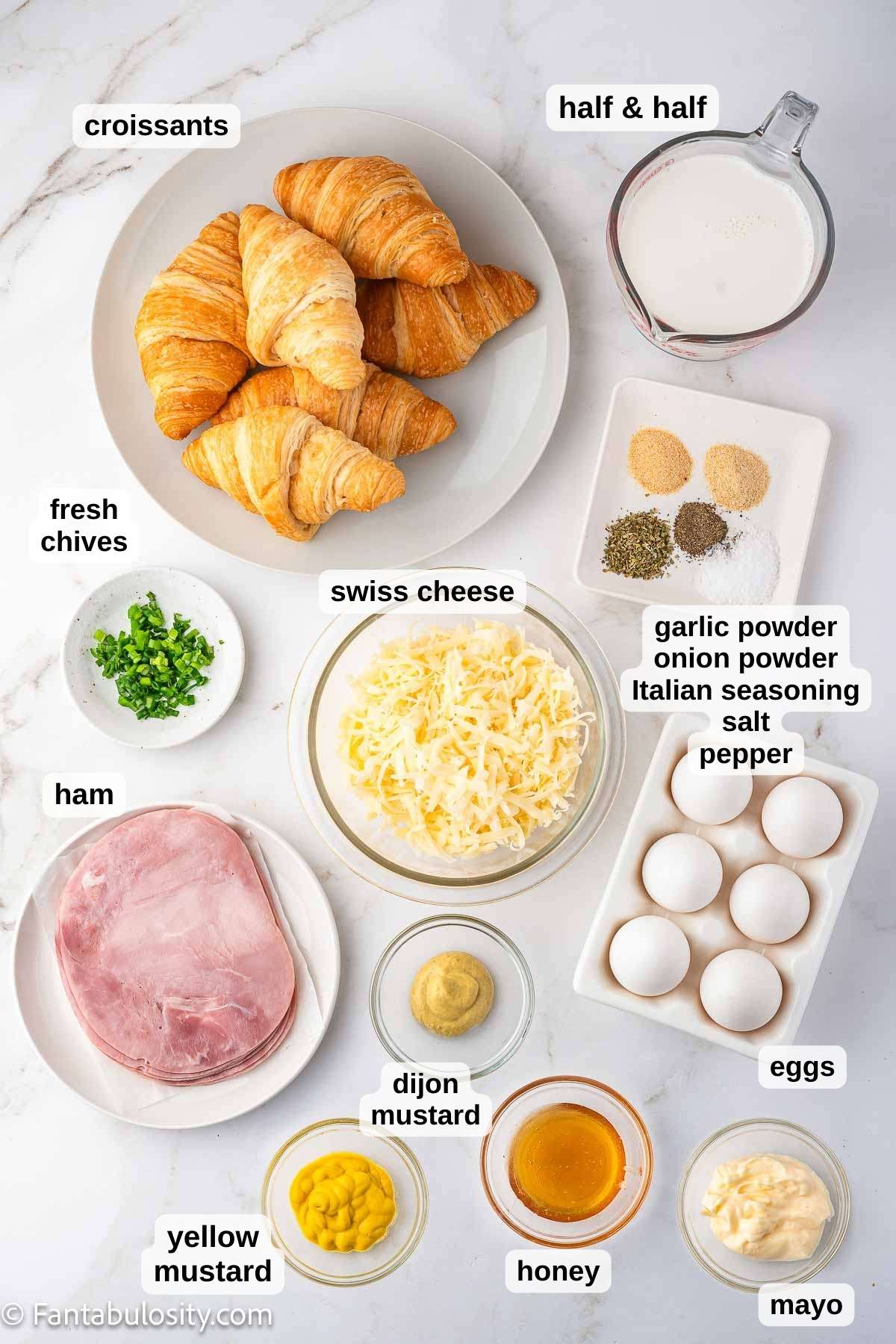 Ingredients for ham and cheese croissant bake on counter.