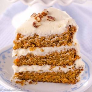 A slice of old-fashioned carrot cake on round, vintage plate.