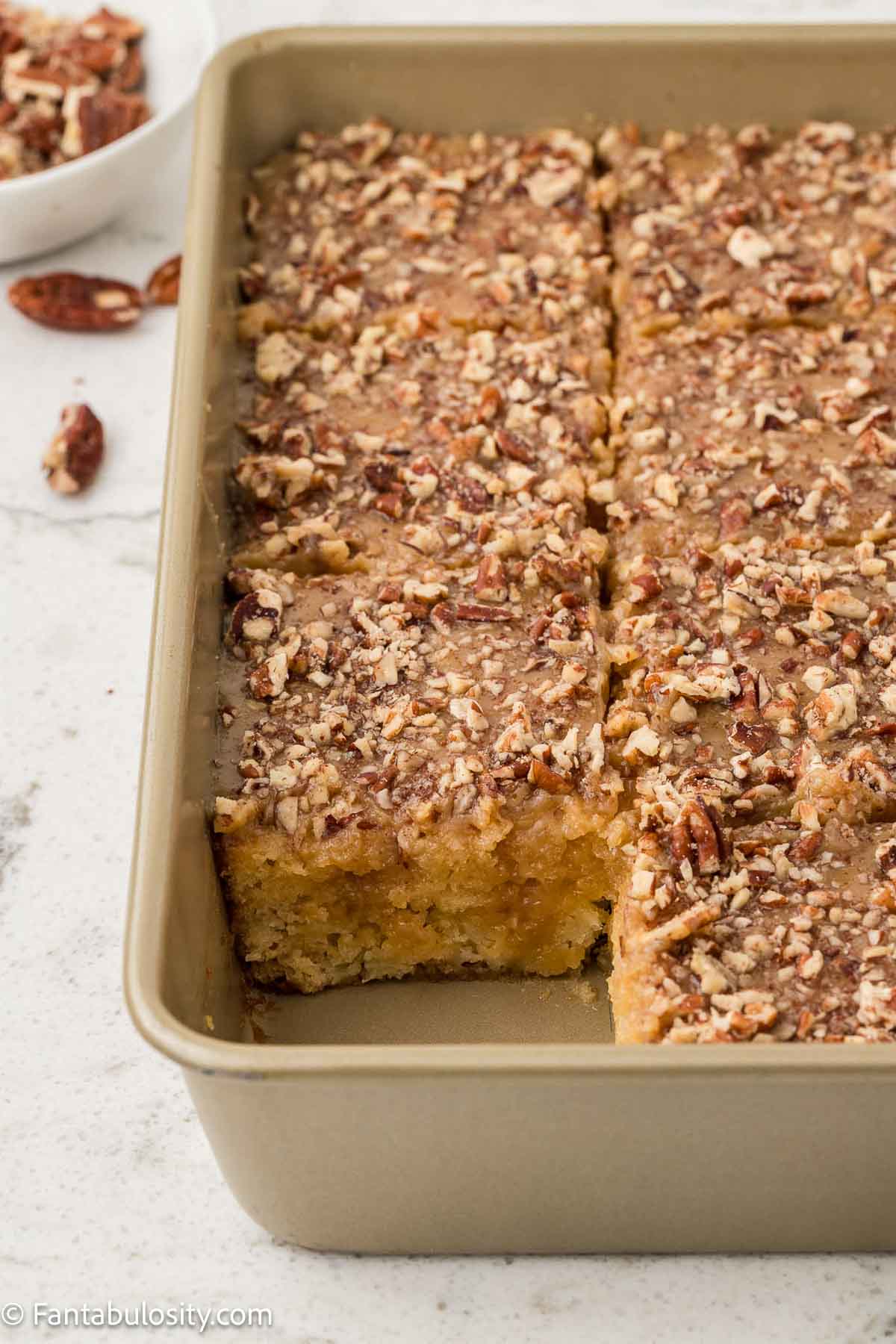 Granny cake cut in to squares, in baking pan.