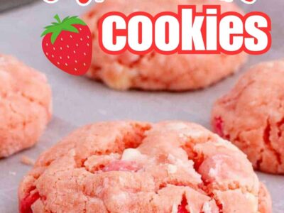 Strawberry cake mix cookies on baking sheet, with white chocolate chips mixed in.