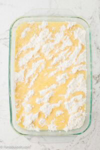Melted butter poured on top of banana dump cake mixture.
