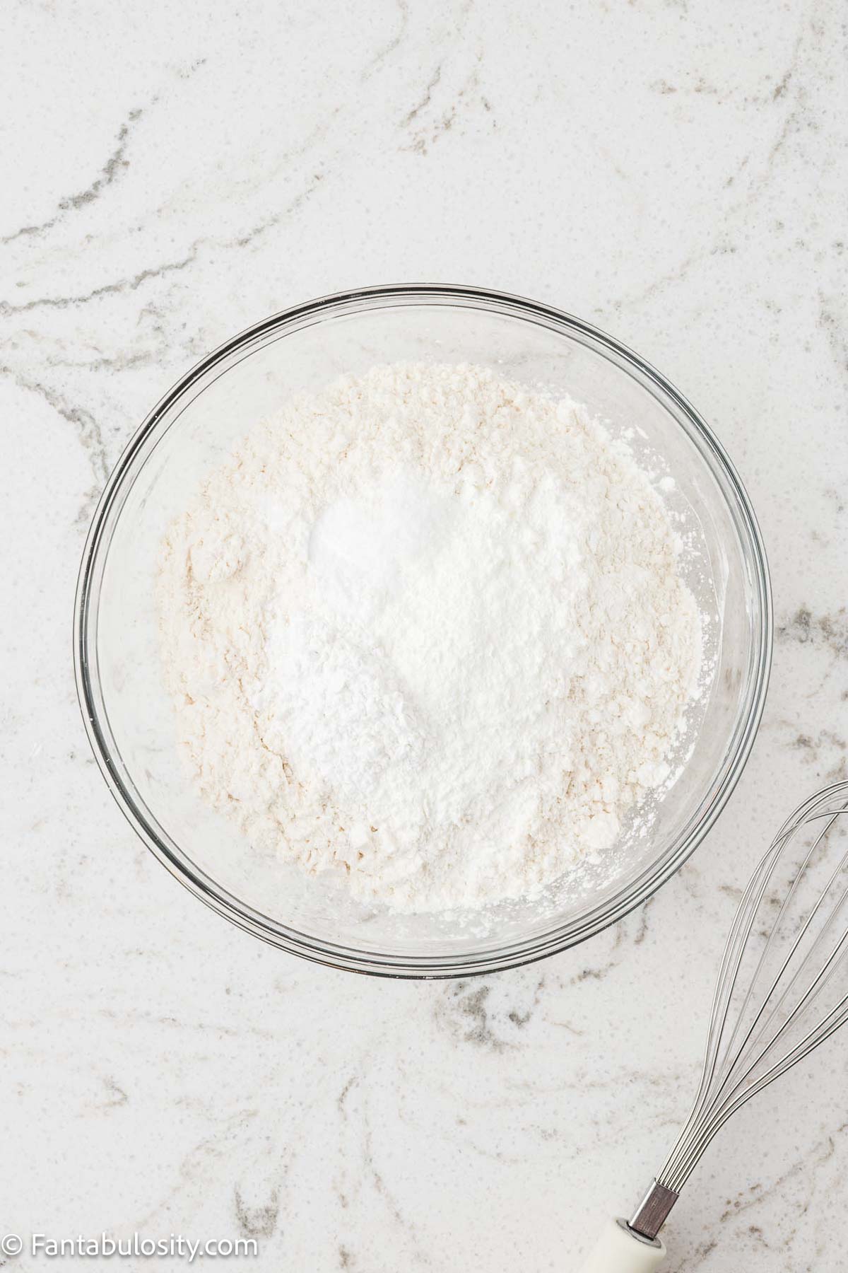 Dry ingredients in mixing bowl, sitting on counter.