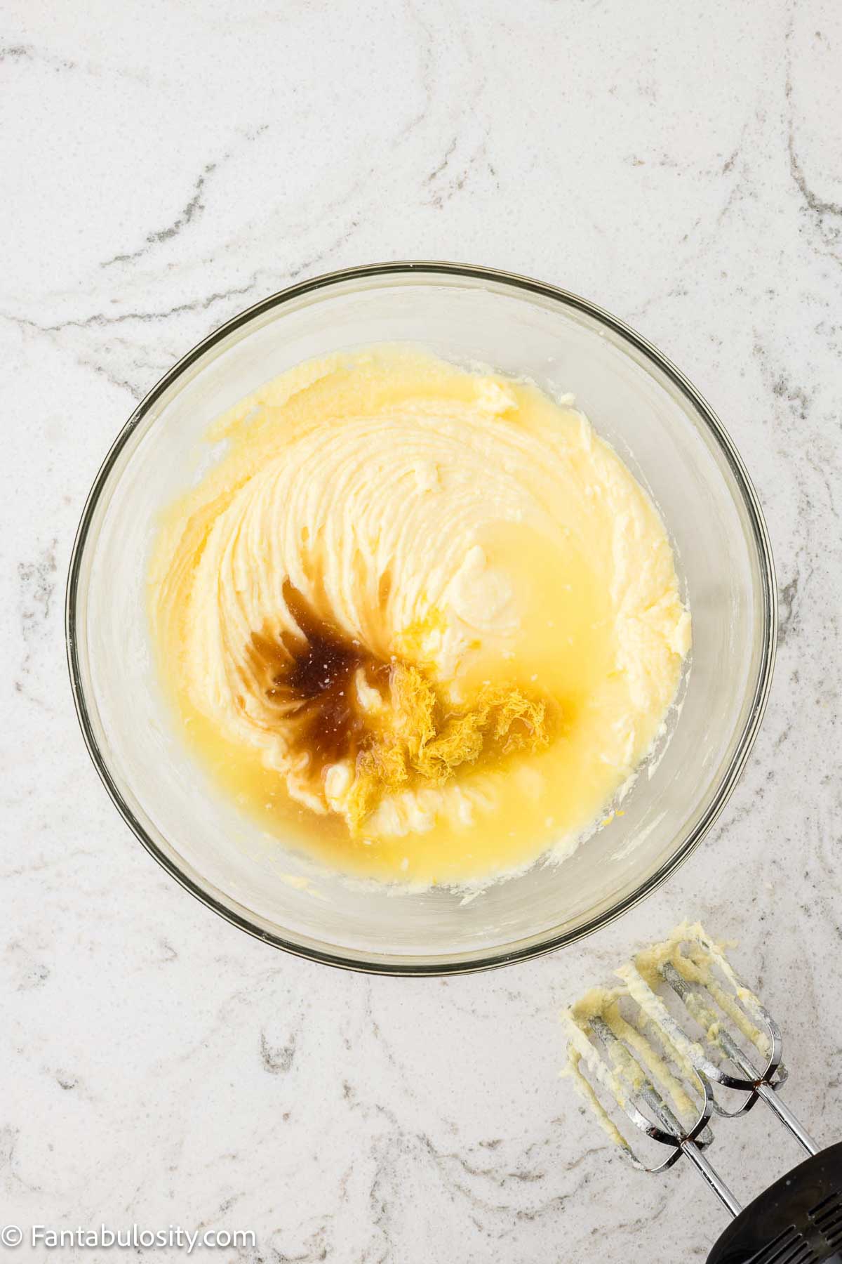 Butter, sugar, eggs, extracts in mixing bowl.