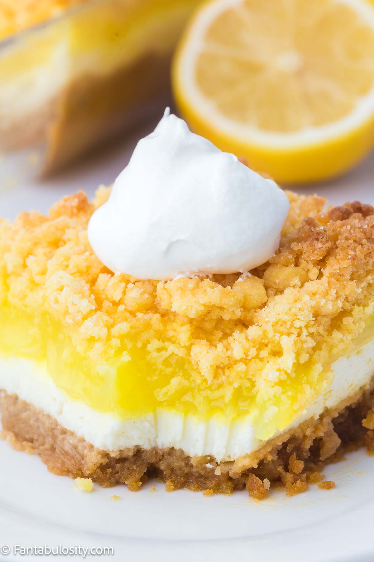 Slice of lemon dump cake on round plate.