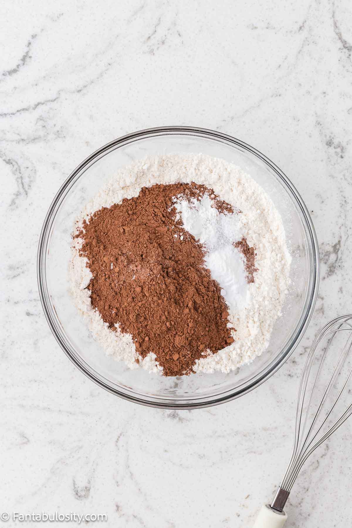 Dry ingredients for chocolate sheet cake, in a mixing bowl.