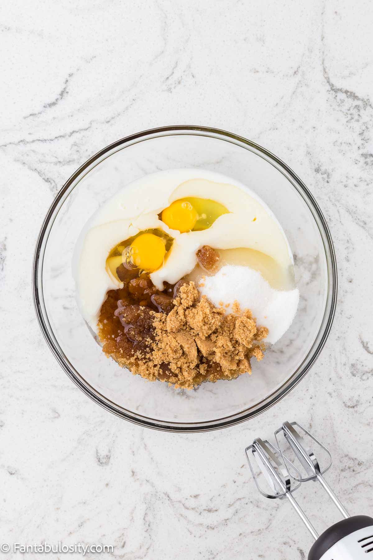 Wet ingredients such as eggs, oil, vanilla, in mixing bowl.