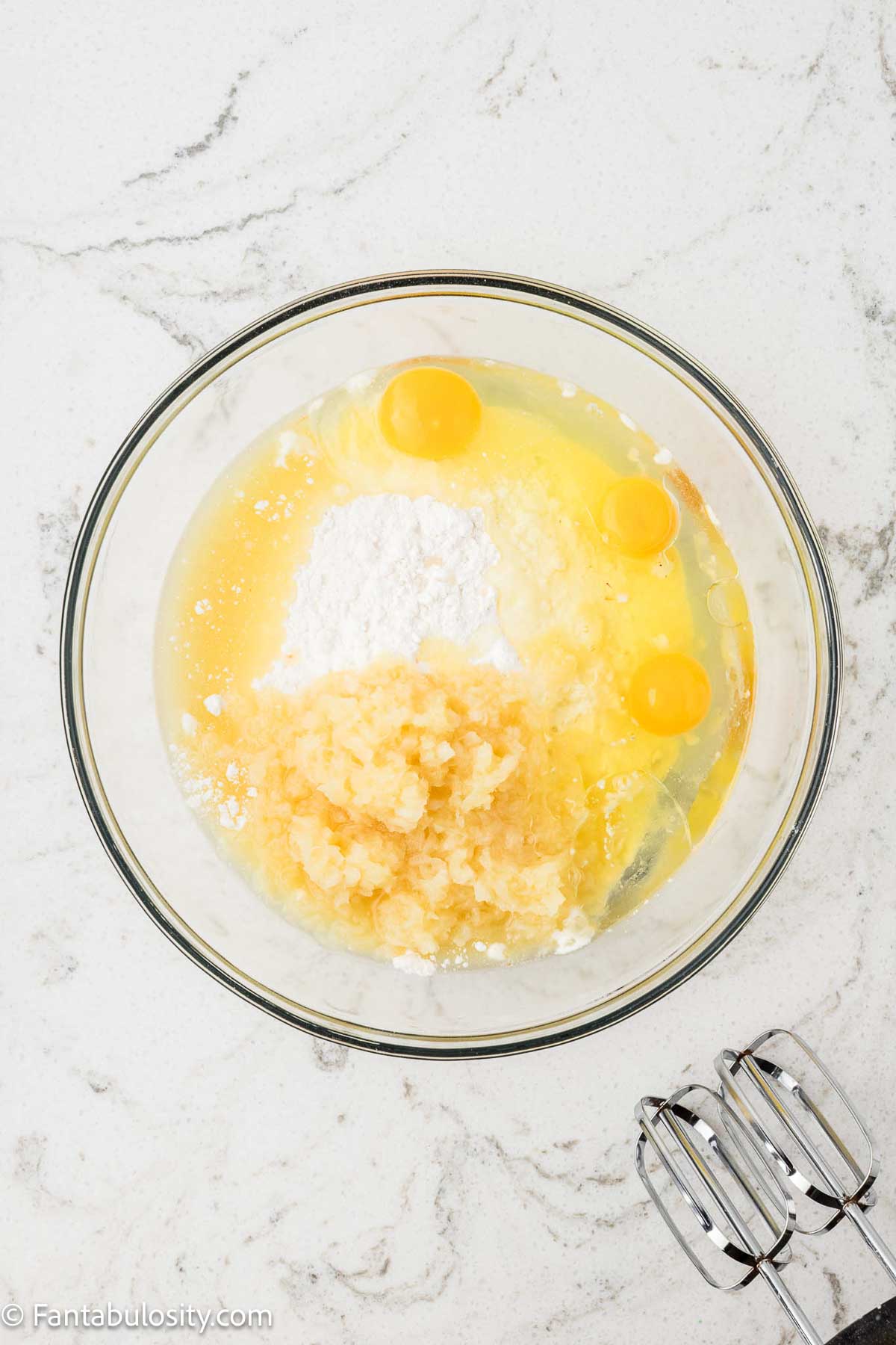 Cake mix, eggs, pineapple, oil and rum extract in mixing bowl.