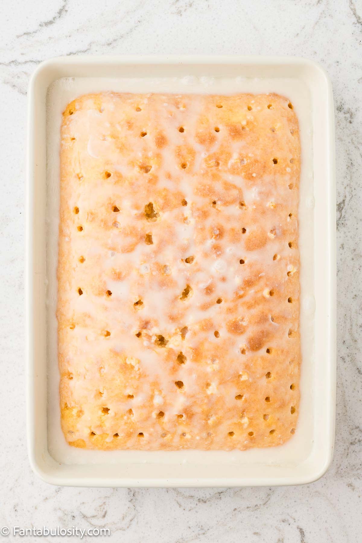 Cream of coconut mixture poured over baked cake.