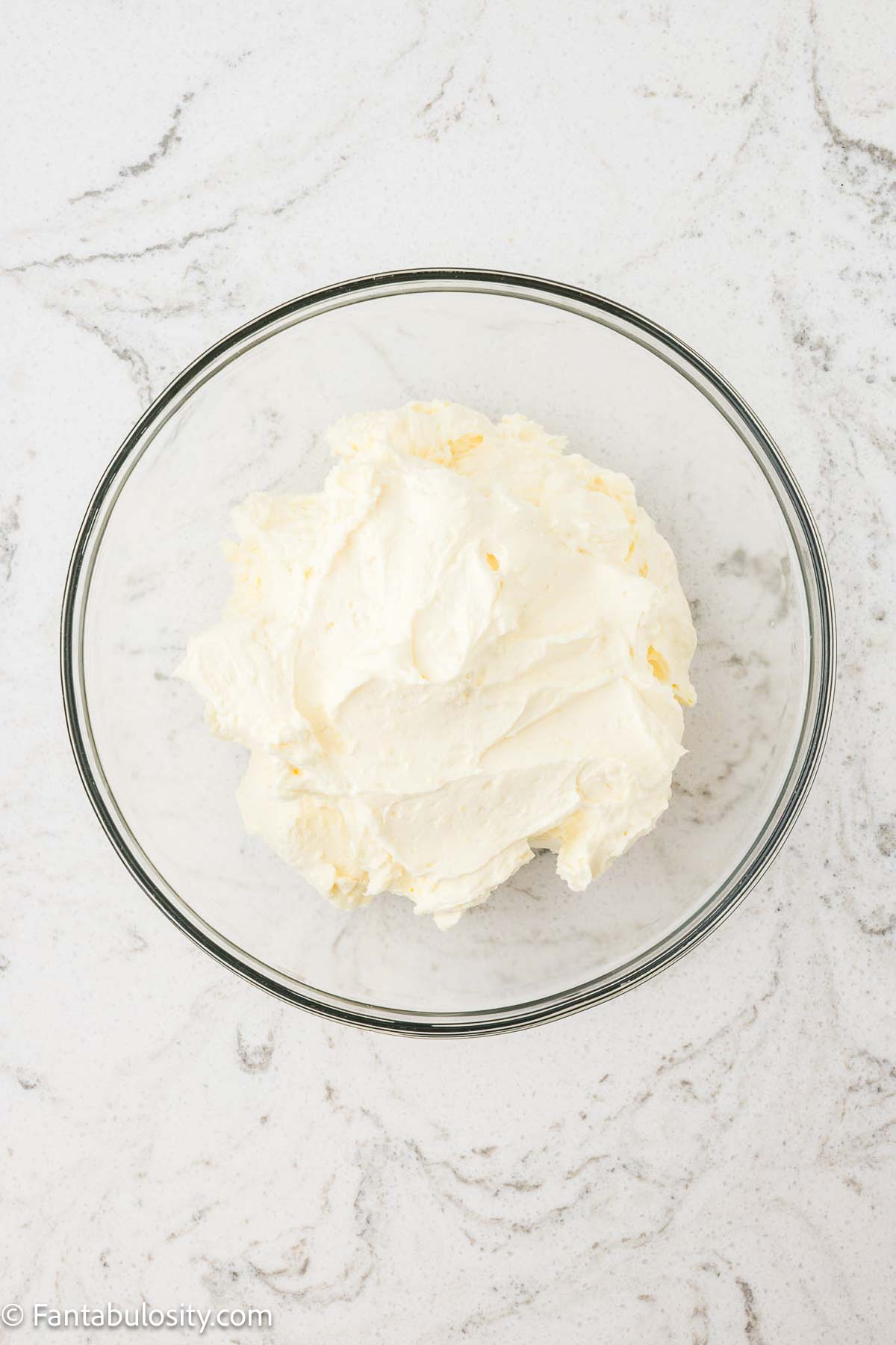 Whipping cream, pudding mix, cream of coconut, powdered sugar and rum extract in mixing bowl.