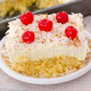 Slice of pina colada cake on a vintage plate.