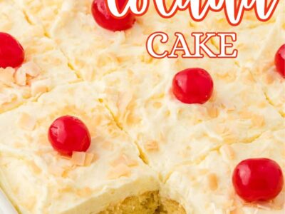 Pina colada cake in baking dish, topped with cherries.