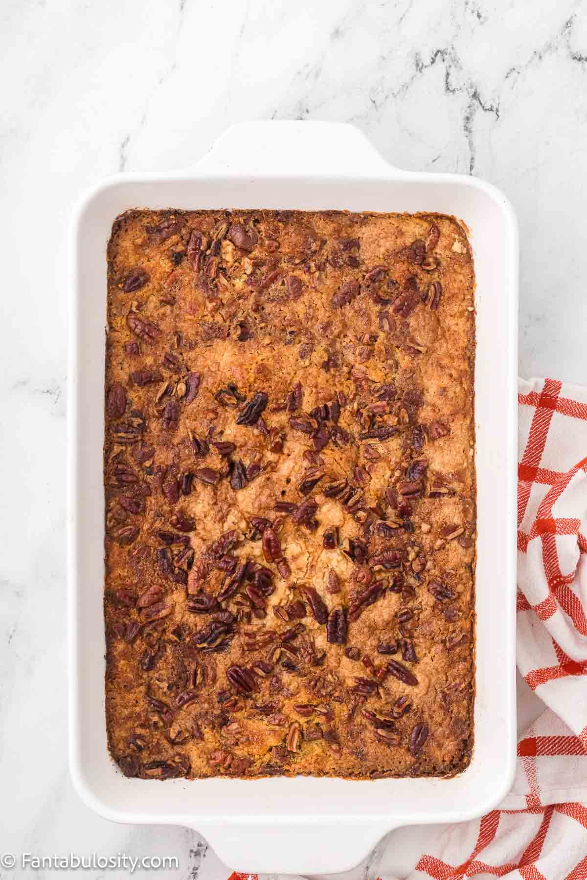 Baked pumpkin dump cake in baking dish.