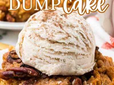 Serving of pumpkin dump cake on a plate, with a scoop of vanilla ice cream.