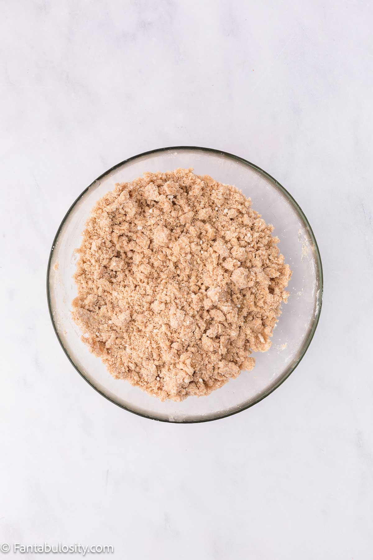 Snickerdoodle cookie mix in bowl mixed with butter.