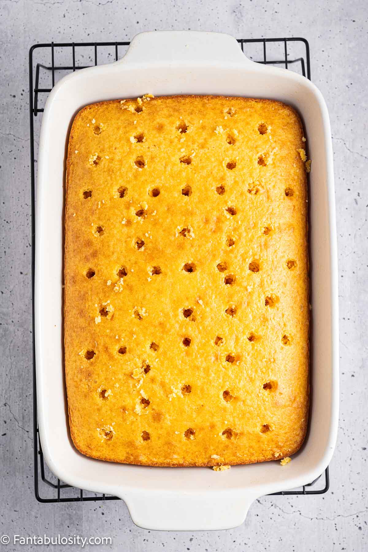 Baked cake with holes poked in the top.