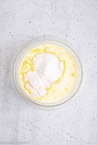 Milk and pudding mix in mixing bowl, ready to be mixed.