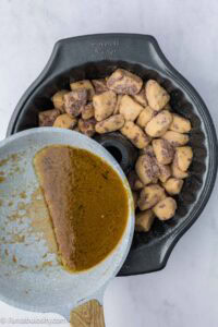 Butter and brown sugar pouring over cinnamon rolls.