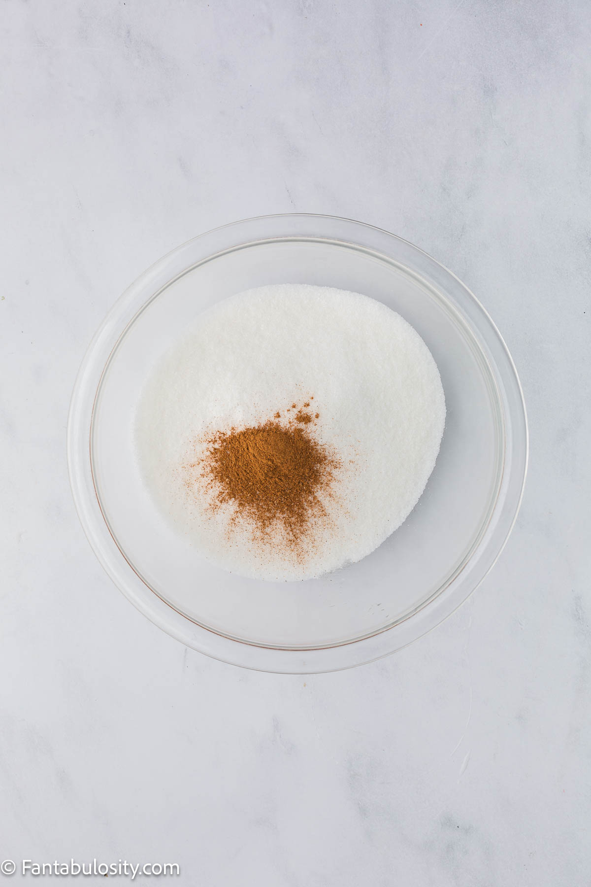 Sugar and cinnamon in mixing bowl.