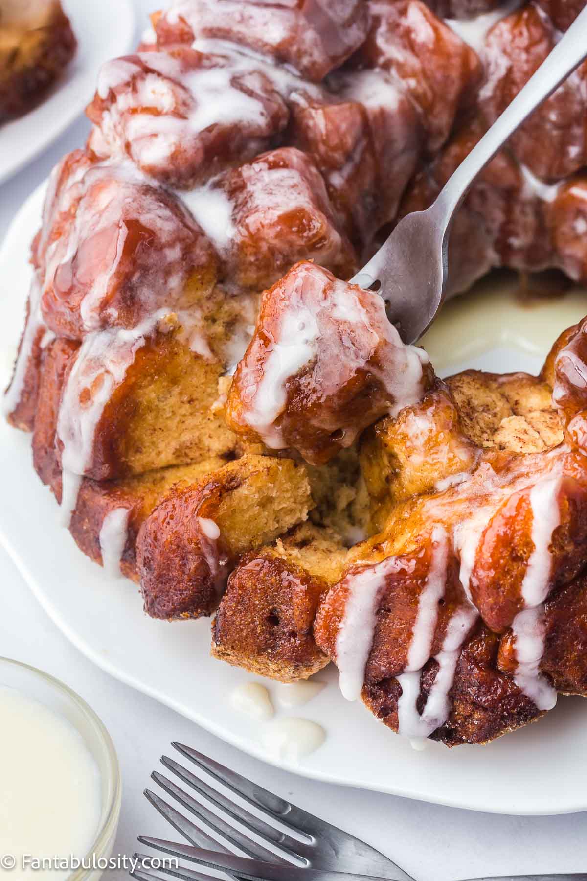 Fork taking pieces off of monkey bread.