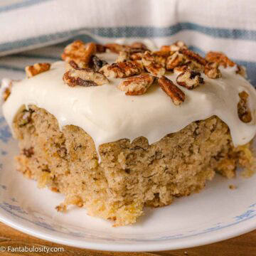 A serving of hummingbird cake on a vintage, round dessert plate.
