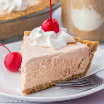 A slice of root beer float pie on a plate with fork.