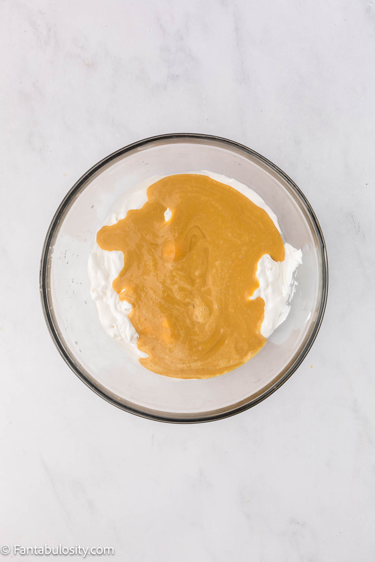 Root beer pudding mixture added to Cool Whip mixture in mixing bowl.
