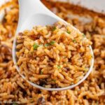A spoonful of stick of butter rice, in dish.