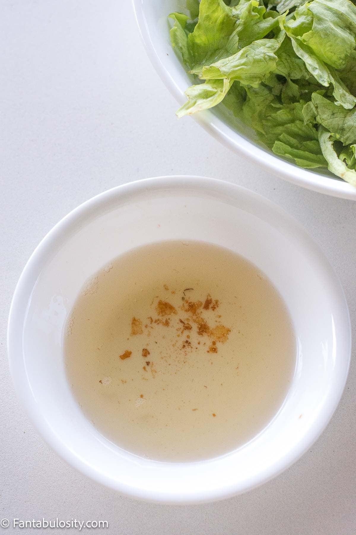 Hot bacon grease in small bowl.