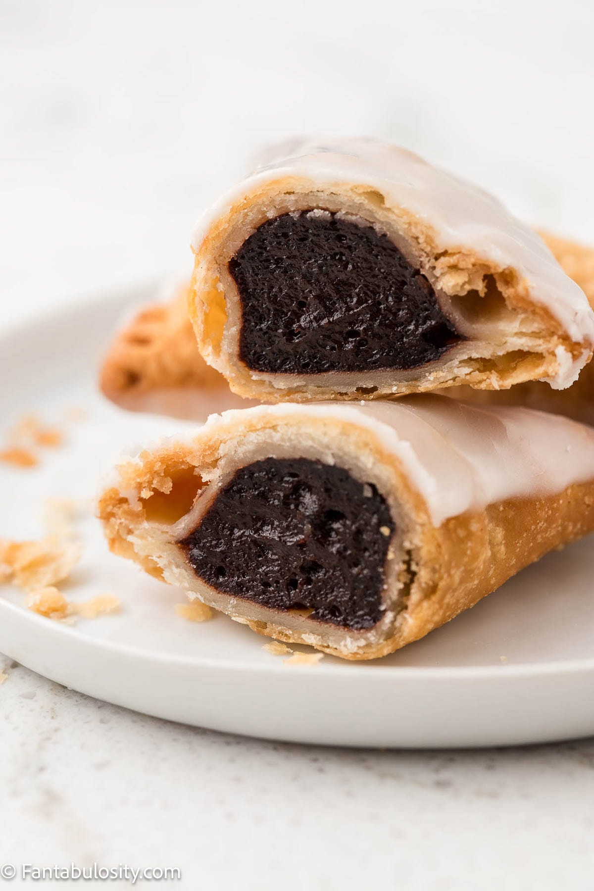 Chocolate fried pie cut in half, showing the middle filling.