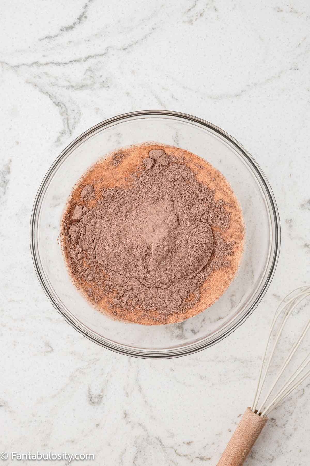 Chocolate pudding mix in mixing bowl with half and half.